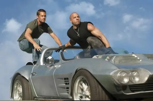 You have got to be kidding. Another Fast and the Furious movie? There were four of them already?  Christ.  Fast Five?  Oh, that's original. For the love of Pete, who greenlights these movies? Wait...what's that? Dwayne "The Rock" Johnson's in it? SOLD. Say what you will about this ridiculous film franchise, but Vin Diesel and The Rock in the same frame is capable of producing enough energy to power a small village for a decade.  There hasn't been collective body mass like this since Predator. Plot: High speed chase movie/souped-up car porn starring two large men named after a type of engine and the naturally occurring solid aggregate of minerals, respectively.So get this: reviews have not been terrible, with actual praise coming from Scott Tobias at The A.V. Club who says: "Like a proper action sequel, itâs bigger, louder, and sillier than its predecessors, but itâs more streamlined, too, smartly dumping the tired underground racing angle in favor of a crisp, hugely satisfying Oceanâs Eleven-style heist movie."Fast Five may be lizard-brain escapismâand thereâs something unsettling about how it lays waste to Rioâs desperately poor favelasâbut nonsense this well-orchestrated is a rare and precious thing."